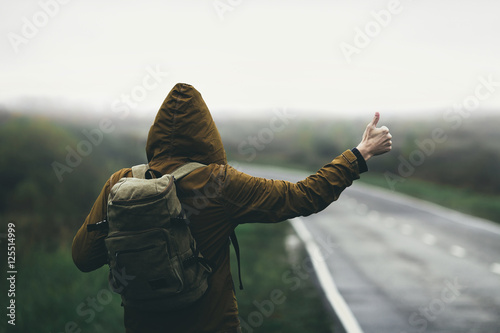 Hitchhiking in autumn mist