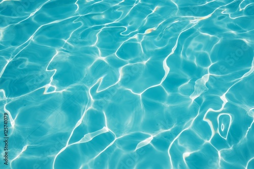 Ripple Water in swimming pool with sun reflection