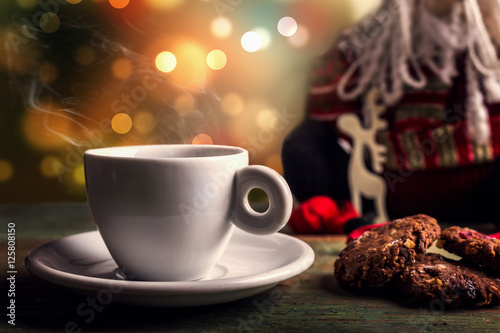 Christmas coffee on table with boheh lights in background