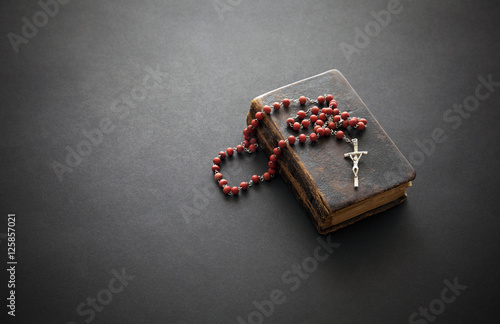 Rosary on the old Bible 