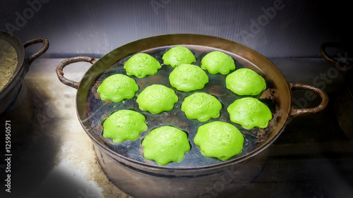 Thai Traditional dessert the name of "Kanom Krok Bai Toey(or Knmcrk) " in ancient pan.
