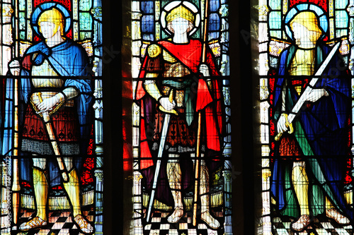 Medieval knight saints on a stained glass window at St Peter's Church Carmathen, Wales, UK