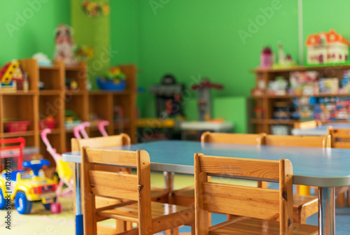 Chairs, table and toys. Interior of kindergarten.