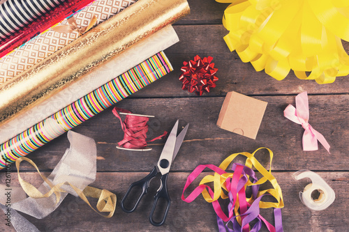 gift wrapping rolls and accessories on the table