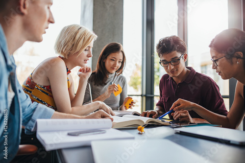 Diverse group of students studying at library