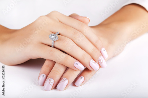 Close up hands of young woman with engagement ring with a diamond. Close up of elegant diamond ring. Close up of elegant diamond ring on the finger. Diamond ring.