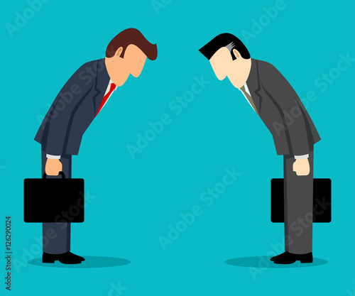 Two businessmen bowing each other