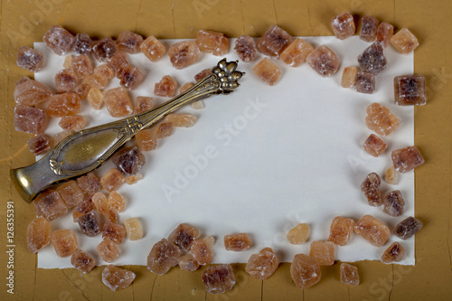 Old spoons and brown sugar cubes with space for text