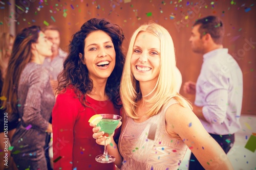 Composite image of portrait of beautiful women having drinks