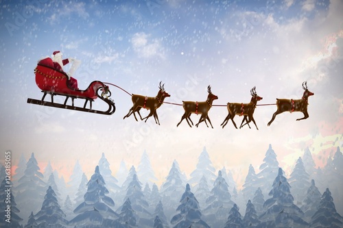 Composite image of side view of santa claus riding on sleigh dur