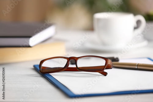 Close up view of glasses on clipboard. Healthy eyes concept