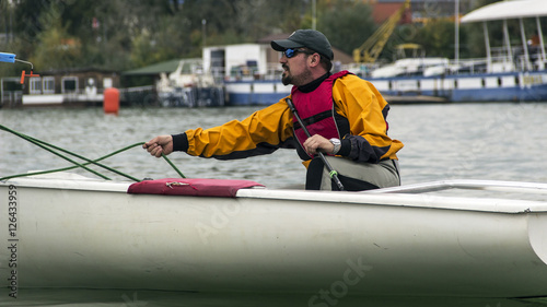 Man in the Finn Class sailboat participates in one of the match race regattas on the Sava river, Belgrade, Serbia