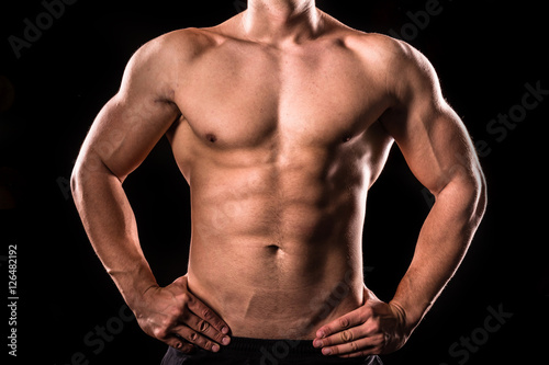 bodybuilder upper body below the neck isolated with black background