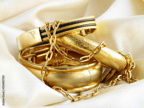 Gold jewelry, bracelets and chains. Luxury accessories.
