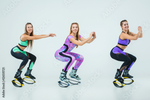 The group of girls, jumping on kangoo training