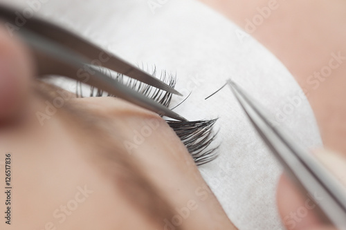 Traditional eyelash extensions. Selective focus. Toned. Makeup close-up.