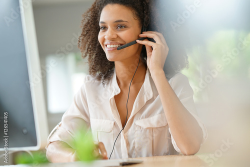 Portrait of customer service assistant talking on phone