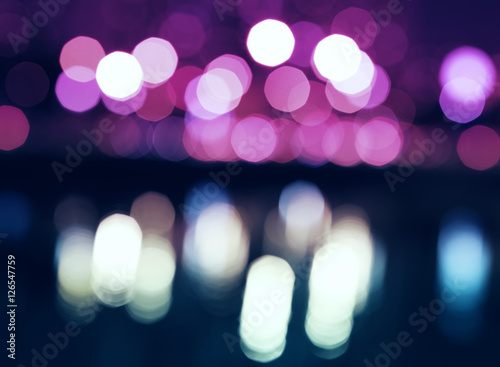 Night city lights bokeh with reflections background
