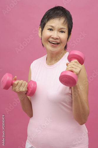 Mature woman with dumbbells