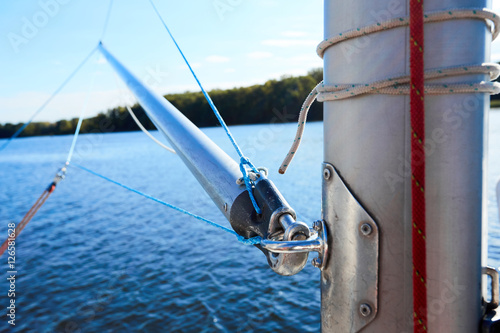 The spinnaker pole is rigged to run from the base of the mast to windward over the side of the boat.