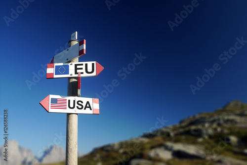 USA and UE flags on mountain signpost. At the top of the agenda concept.