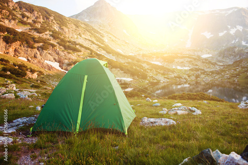 Camping green tent on the grass