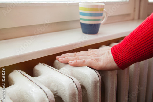 touching the radiator to check whether heated