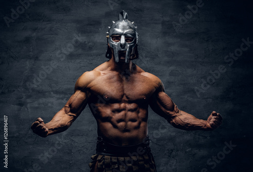 Muscular man in a gladiator silver helmet.