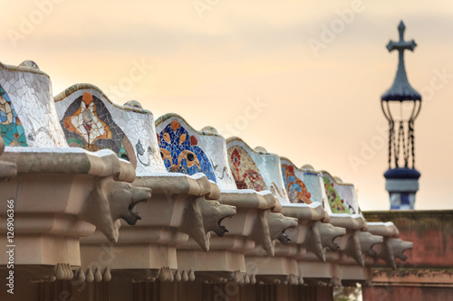 Park Guell in Barcelona. Doric columns with creature heads support the central terrace with serpentine seating