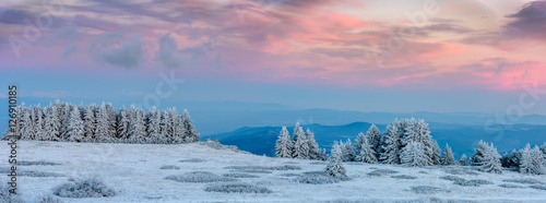 Amazing pink purple winter sunset in the mountains - beautiful frozen landscape - colorful panorama
