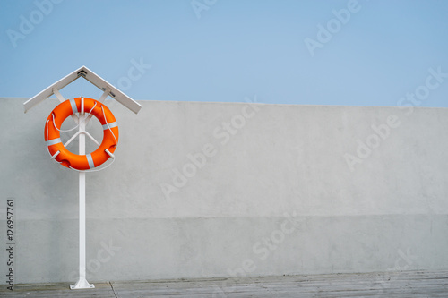 Orange life buoy on the pier