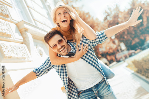 Young man giving his girlfriend a piggyback