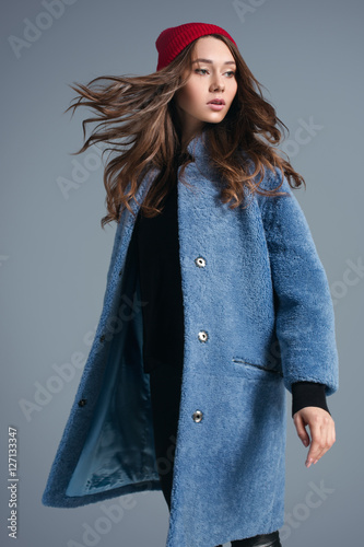 Girl in blue fur coat and red hat