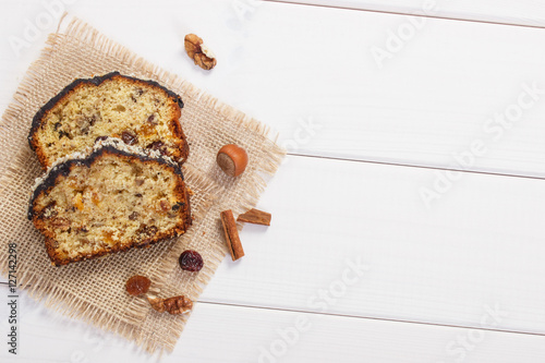 Fresh baked fruitcake on white boards, copy space for text