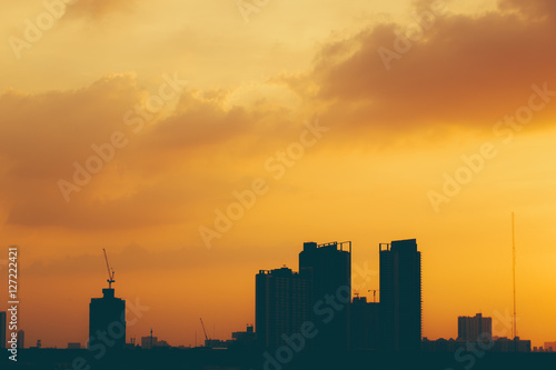 silhouette of city building in dusk sky.