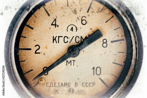 Air pressure gauge, old vintage soviet(Made in USSR), pressure gauge stylised as aged old b&w sepia toned photos. Industry background.