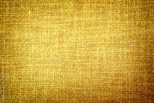 Old gold cloth texture high contrasted with vignetting effect