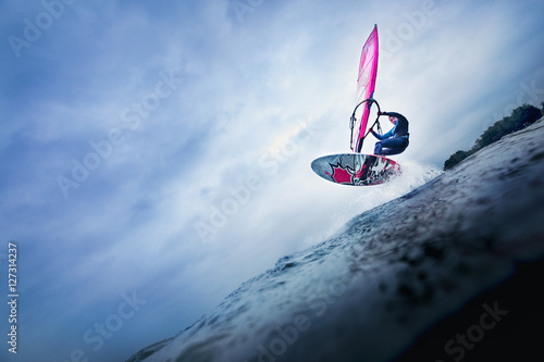 high jump of a windsurfer over a wave
