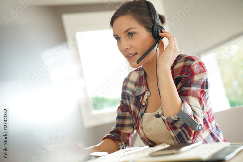 Customer service representative working from home on laptop