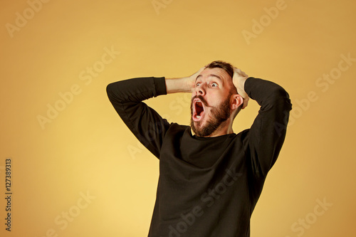 Portrait of young man with shocked facial expression