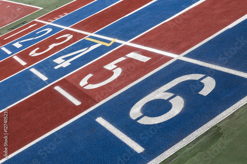 Running track with numbers from 1 to 6. Shot in a unique angle. Blue, red, white and green colors. 