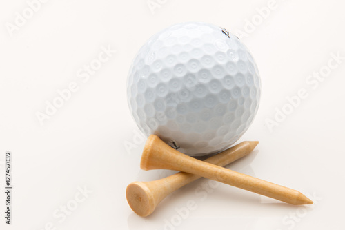 Golf ball and tees on a white background.