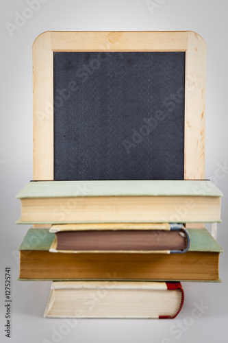 Stack of books with blackboard