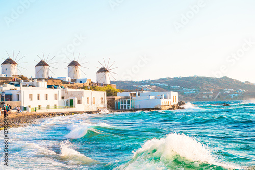 Famous view of traditional greek windmills on Mykonos island at sunrise, Cyclades, Greece