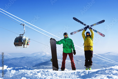 Snowboarder and skier on mountain