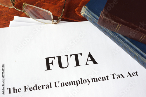 Papers with FUTA Federal Unemployment Tax Act.