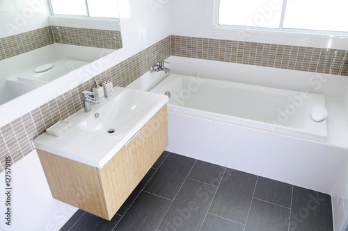 White sink and dispenser in bathroom