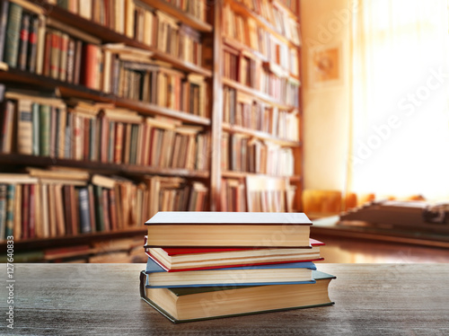 Stack of books on table at library