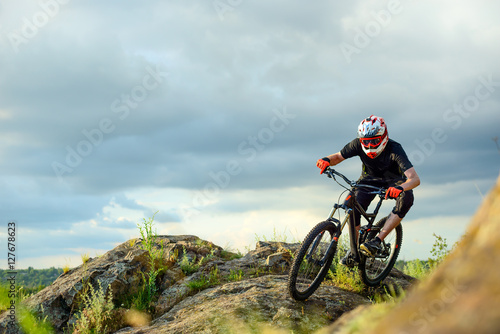 Professional Cyclist Riding the Bike on the Rocky Trail. Extreme Sport.