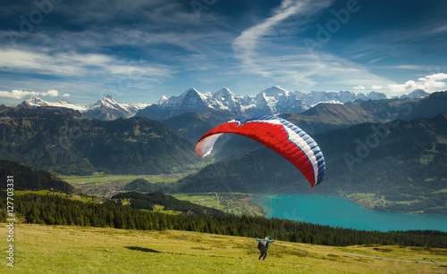 Paraglider taking off in front of spectacular Swiss scenery, Bernese Oberland, Switzerland.